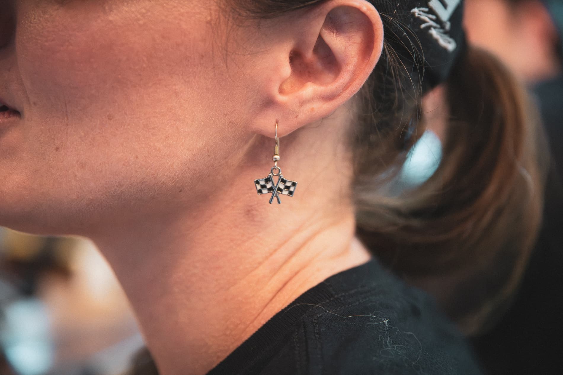 Close-up of a checkered-flag earring.