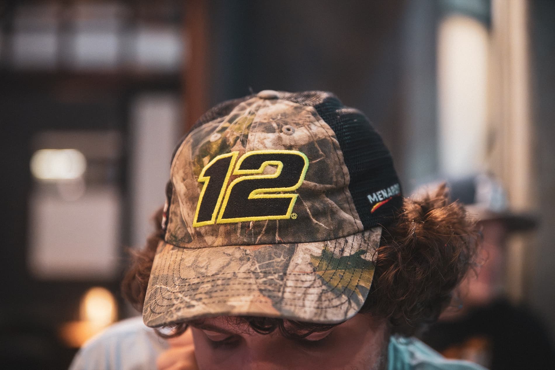 A camouflage No. 12 Menards cap seen from above.