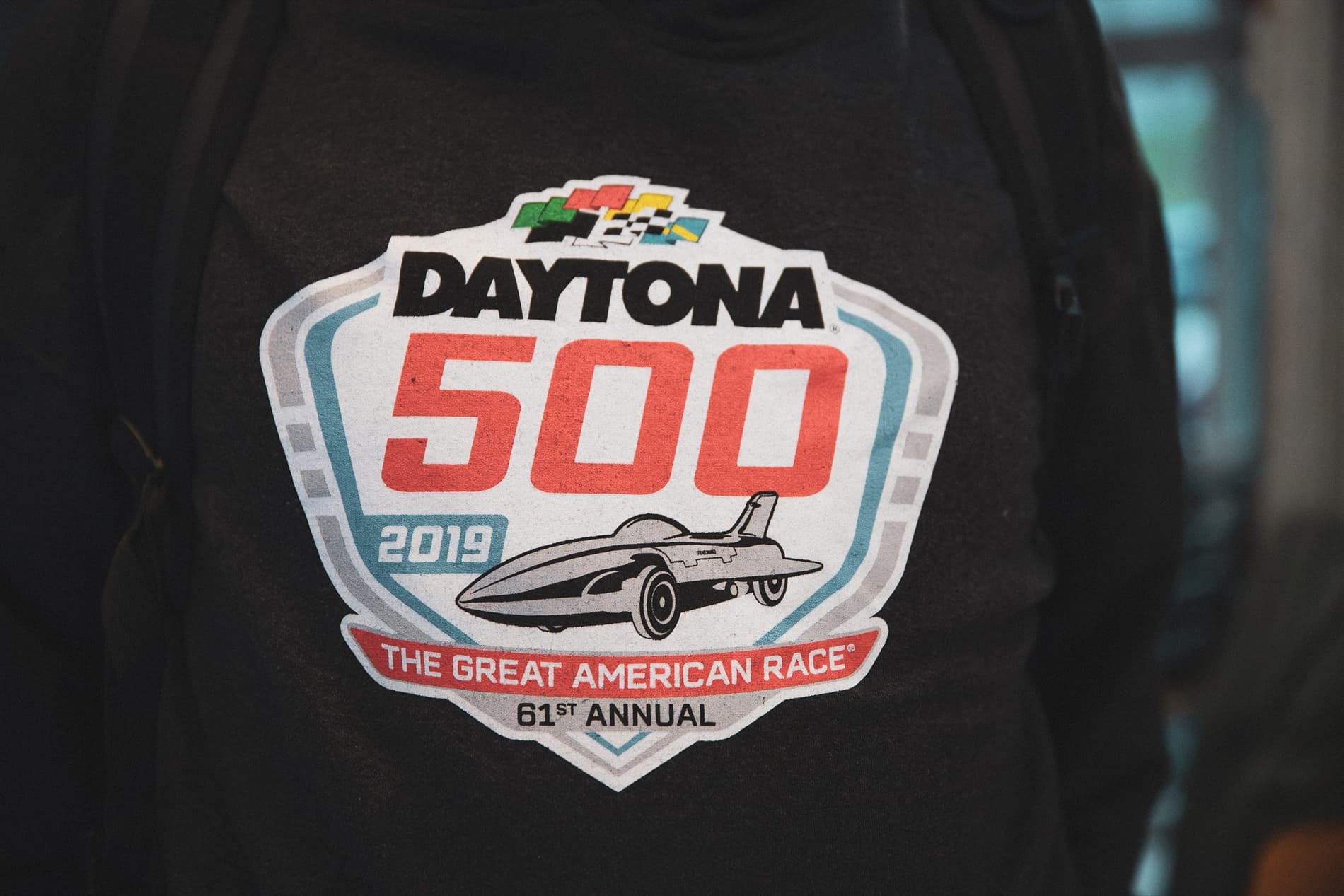 Close-up of a 2019 Daytona 500 logo on a dark sweatshirt.